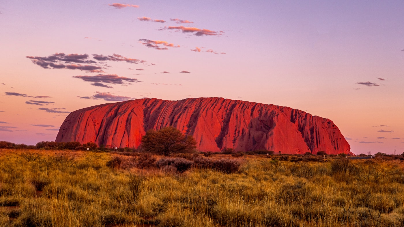 Uluru glowing red at sunset in the Northern Territory, Australia